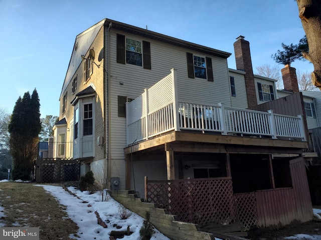 view of snow covered rear of property