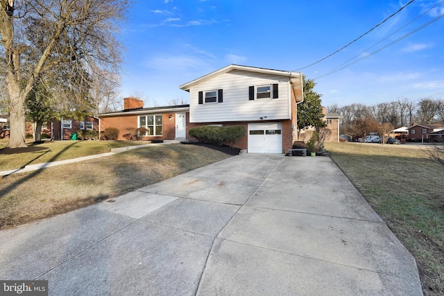 tri-level home with a garage and a front lawn