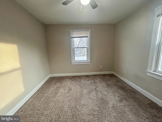 empty room featuring carpet floors and ceiling fan