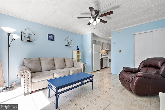 living room featuring ornamental molding, ceiling fan, and light tile patterned flooring