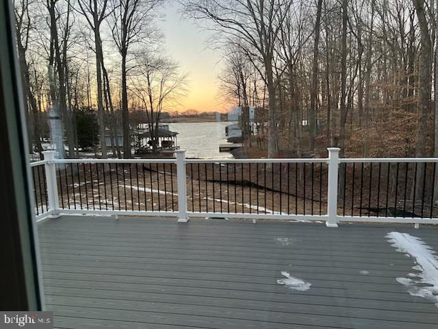 wooden terrace featuring a water view