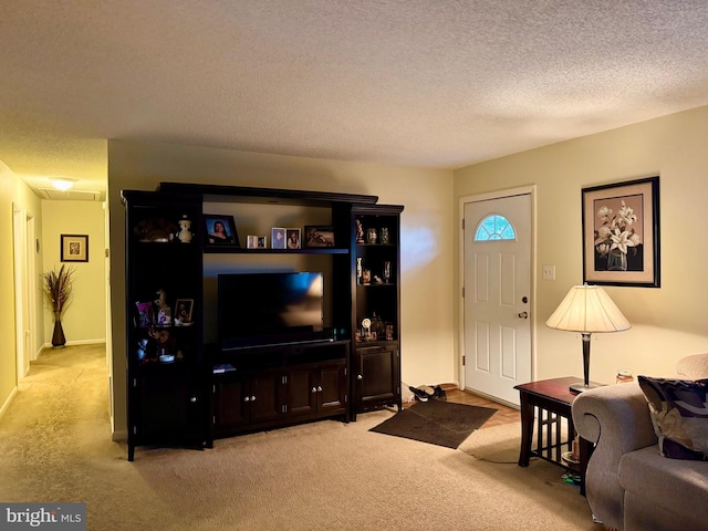 carpeted living room with a textured ceiling