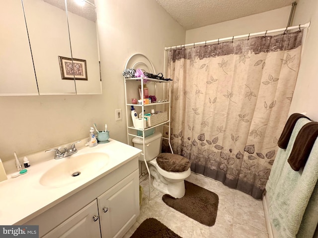 bathroom with toilet, vanity, a textured ceiling, and walk in shower