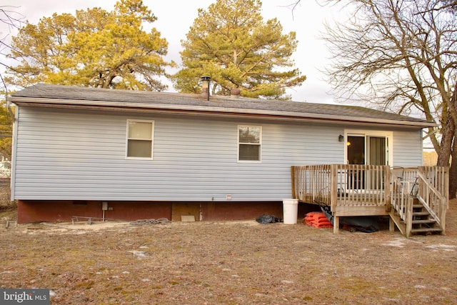 back of house with a wooden deck