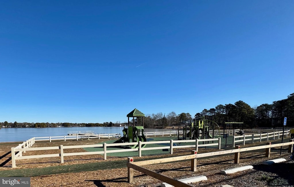 view of yard with a playground and a water view