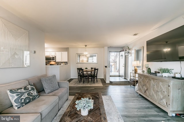 living room featuring hardwood / wood-style flooring and a chandelier