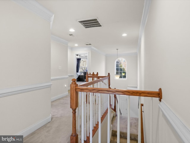 hallway featuring light carpet and ornamental molding