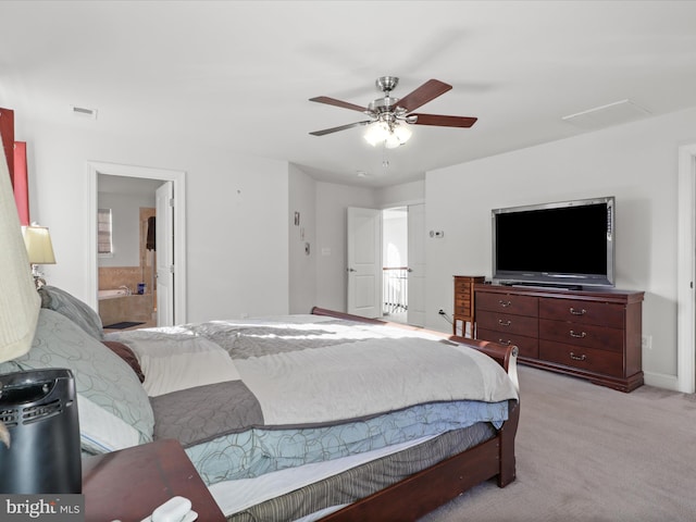 carpeted bedroom featuring ceiling fan and ensuite bath