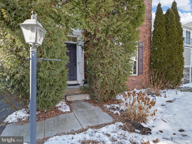 view of snow covered property entrance