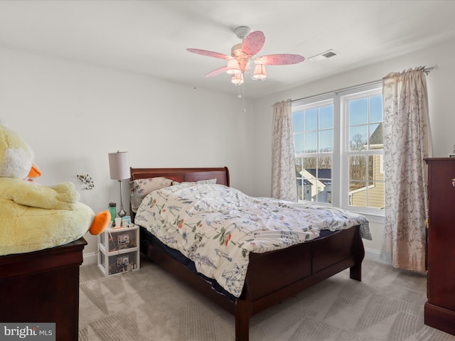 bedroom featuring light carpet and ceiling fan