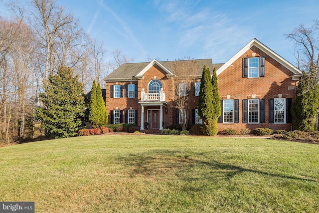 colonial-style house with a front yard