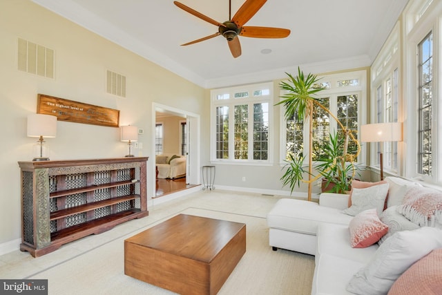 living room featuring crown molding and ceiling fan