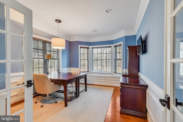 office featuring wood-type flooring, crown molding, and french doors