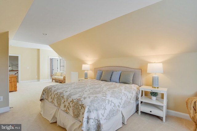 carpeted bedroom with lofted ceiling