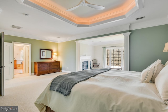 bedroom with light colored carpet, ornamental molding, and a raised ceiling