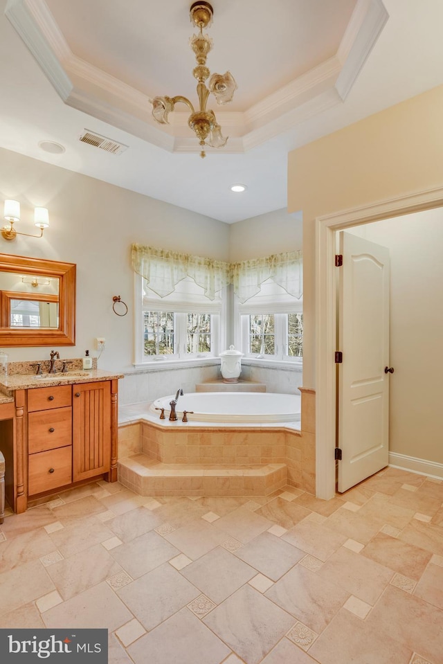 bathroom with ornamental molding, a relaxing tiled tub, a notable chandelier, and a tray ceiling