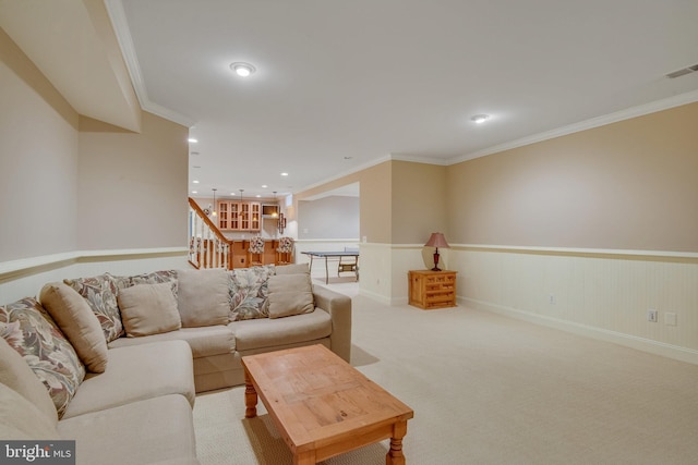 living room featuring ornamental molding and carpet