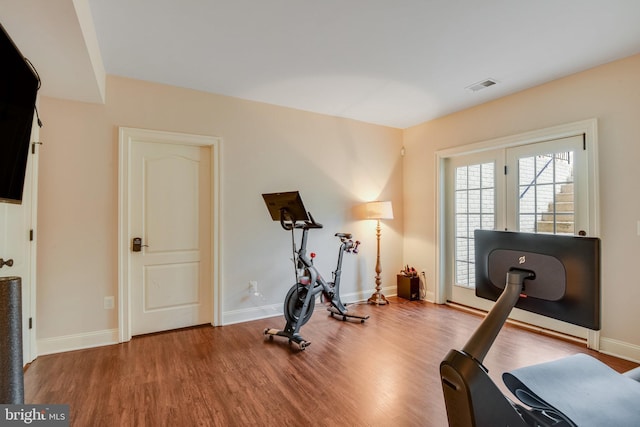 workout area with hardwood / wood-style flooring