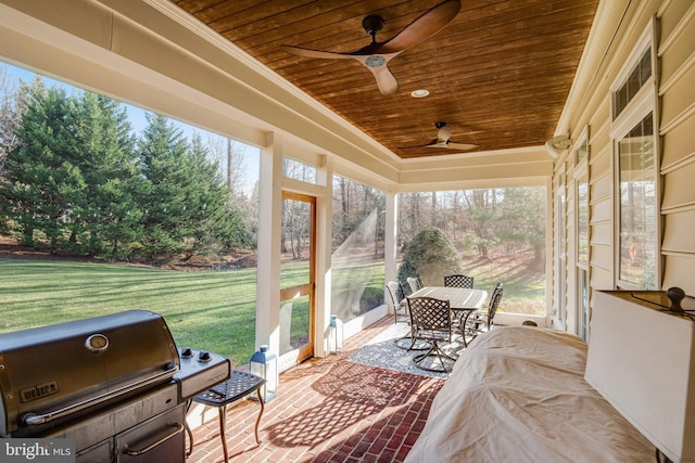 sunroom / solarium with wood ceiling and ceiling fan