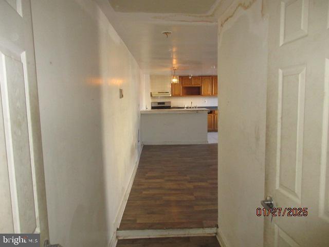 corridor with dark wood-type flooring