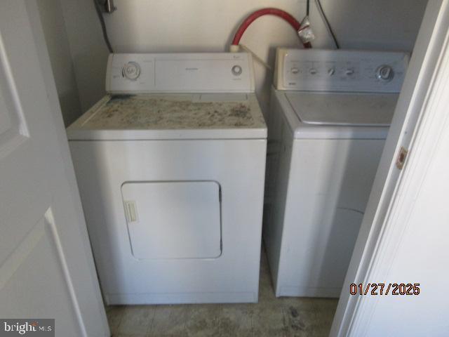 clothes washing area with washing machine and dryer