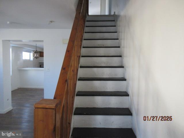 staircase with hardwood / wood-style floors