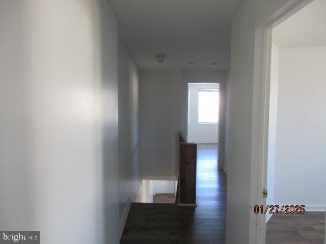 hallway featuring dark hardwood / wood-style flooring