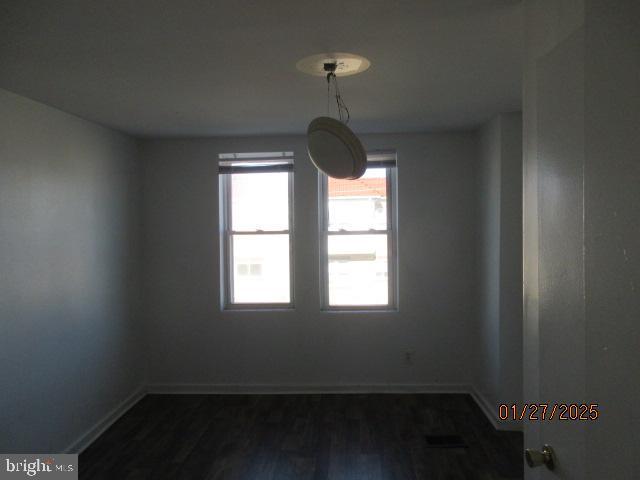 unfurnished room with dark hardwood / wood-style flooring