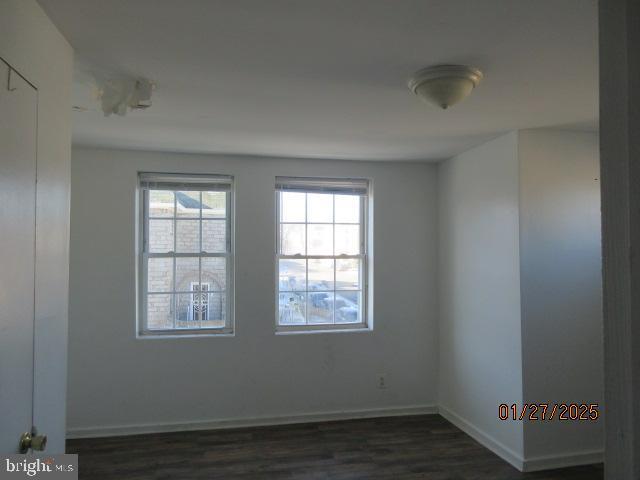 spare room with dark hardwood / wood-style flooring