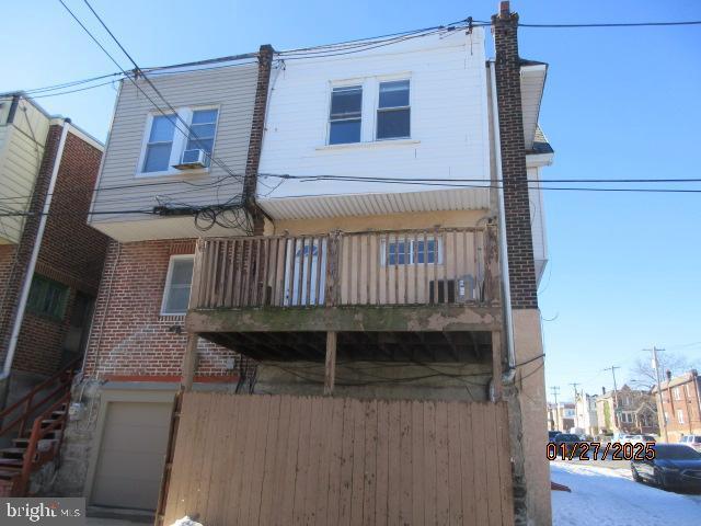 view of front of property featuring cooling unit and a garage