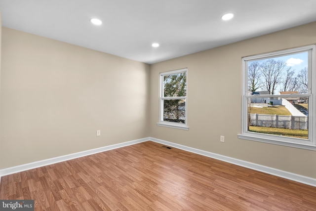 unfurnished room with hardwood / wood-style floors