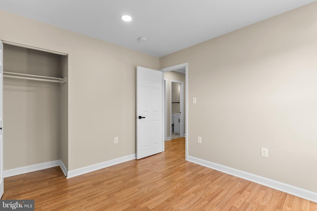 unfurnished bedroom featuring light hardwood / wood-style floors and a closet