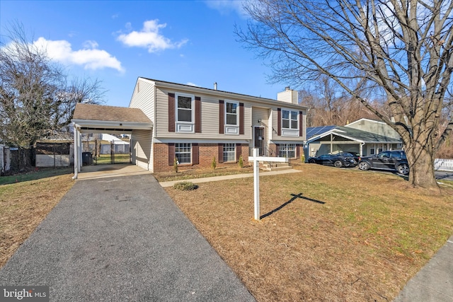 split foyer home with a carport and a front yard