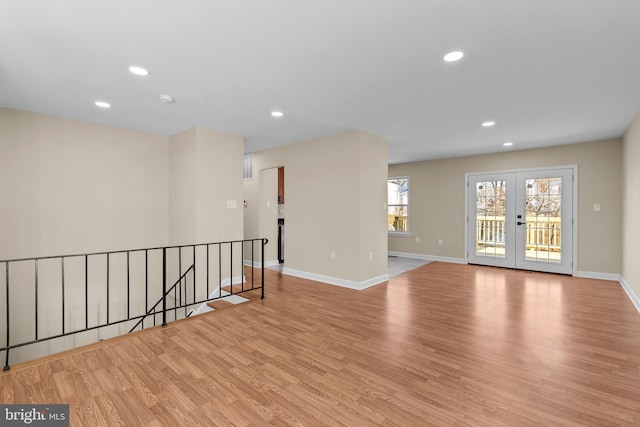 unfurnished room featuring light hardwood / wood-style floors and french doors