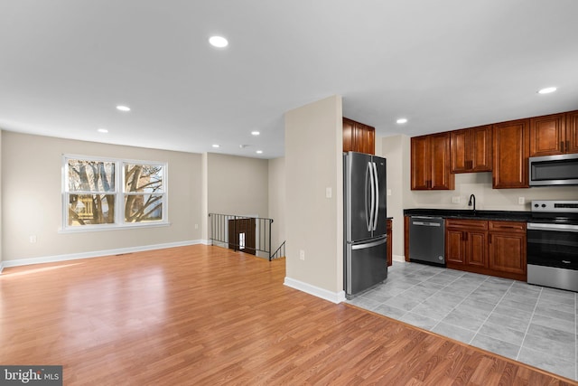 kitchen featuring light wood-type flooring and appliances with stainless steel finishes