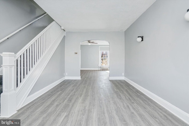 spare room with light hardwood / wood-style floors and ceiling fan