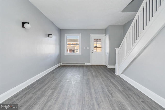 foyer entrance featuring hardwood / wood-style flooring and baseboard heating