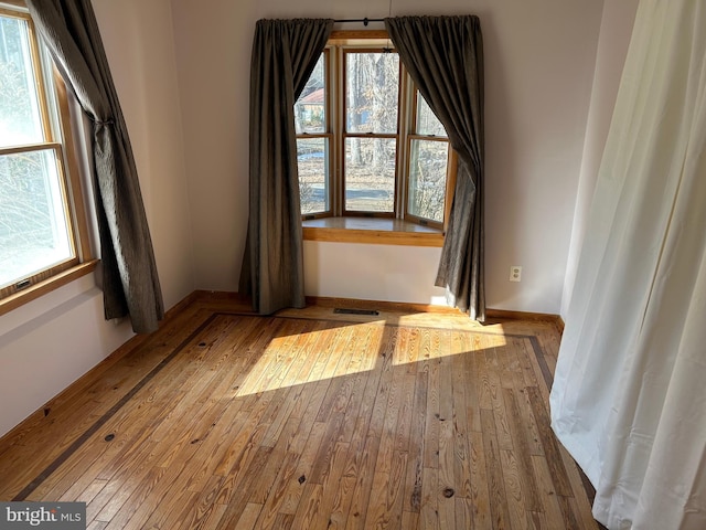 unfurnished room featuring hardwood / wood-style flooring