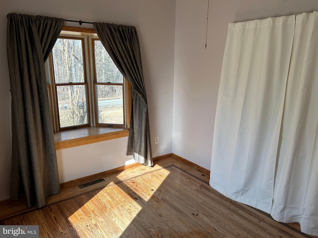 spare room with hardwood / wood-style flooring