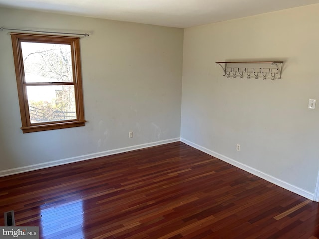 unfurnished room featuring dark hardwood / wood-style flooring