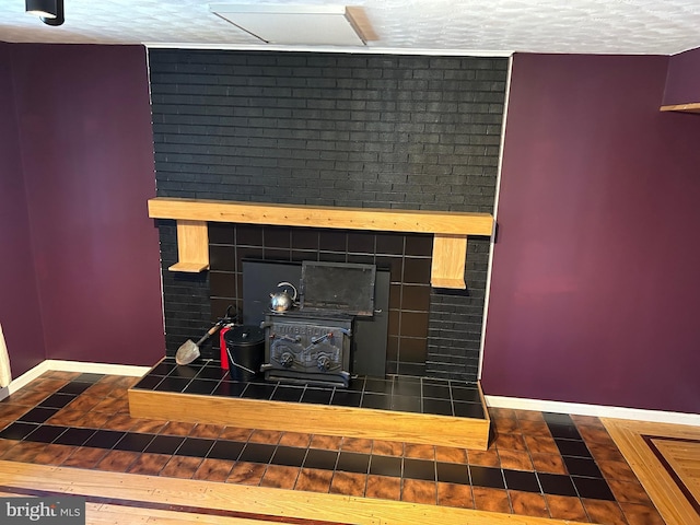 details featuring a wood stove and a textured ceiling