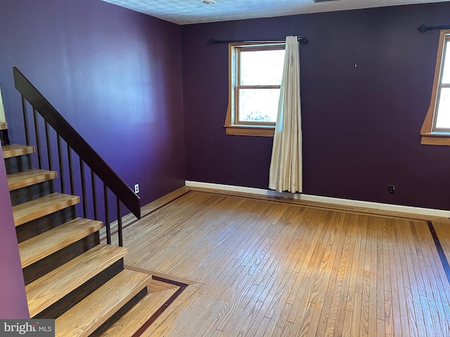 unfurnished room with hardwood / wood-style floors