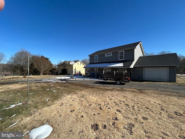 back of property with a garage