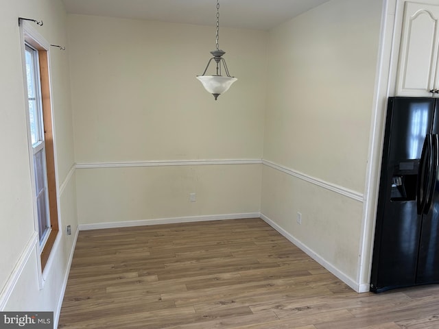 unfurnished dining area featuring light hardwood / wood-style floors