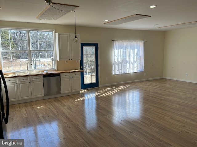 kitchen featuring white cabinetry, a healthy amount of sunlight, light hardwood / wood-style floors, and dishwasher