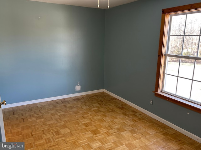 empty room featuring light parquet floors and a wealth of natural light