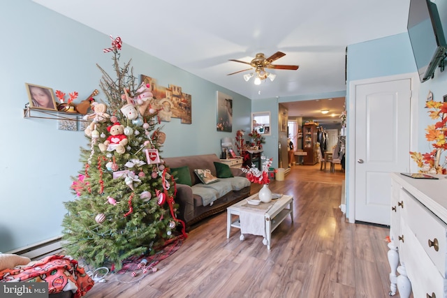 living room featuring ceiling fan, wood-type flooring, and a baseboard radiator