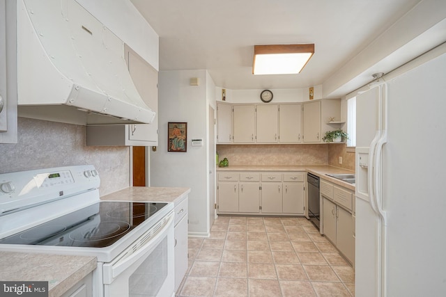 kitchen with white appliances, light tile patterned floors, light countertops, under cabinet range hood, and backsplash