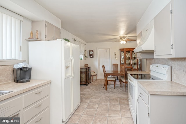 kitchen with white appliances, tasteful backsplash, a ceiling fan, light countertops, and under cabinet range hood