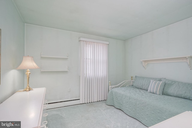 bedroom featuring a baseboard heating unit and carpet